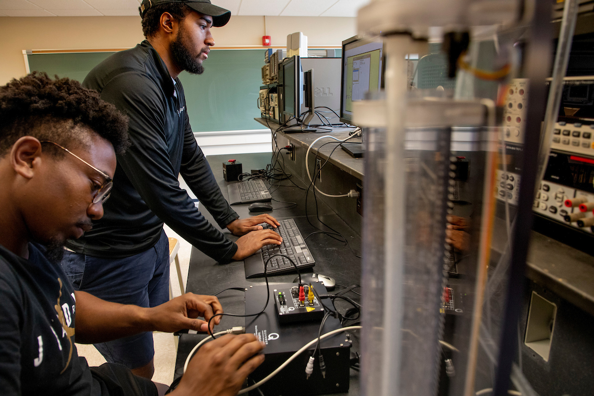 Two male students working on PID Control Design for linear control systems